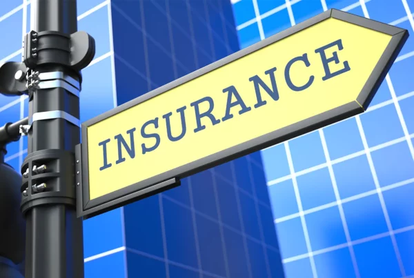 insurance written on street sign with skyscraper on background